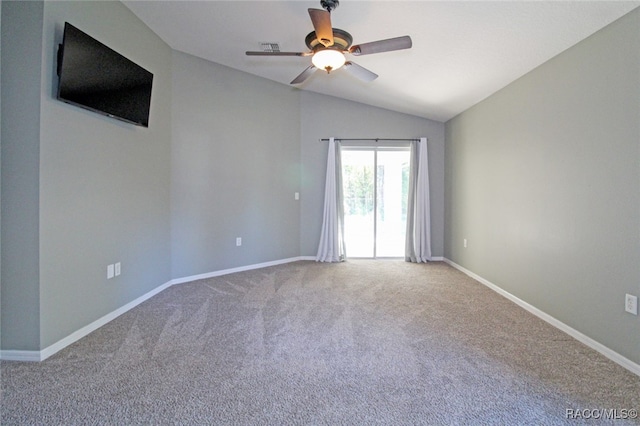 spare room featuring ceiling fan, carpet, and lofted ceiling