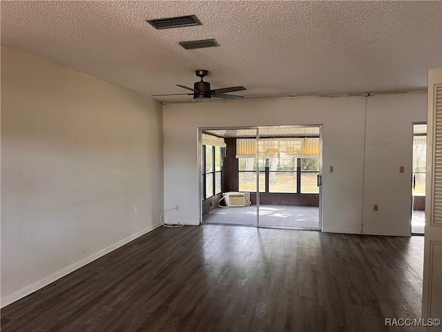 empty room featuring ceiling fan, dark hardwood / wood-style floors, and a textured ceiling