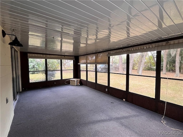 unfurnished sunroom with a wall mounted AC