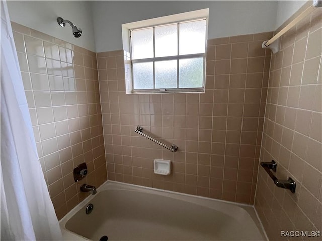 bathroom with shower / bath combination with curtain