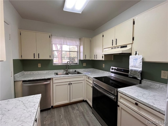 kitchen with cream cabinetry, dark hardwood / wood-style floors, sink, and appliances with stainless steel finishes