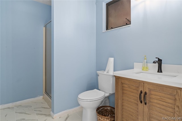 bathroom featuring vanity, an enclosed shower, and toilet