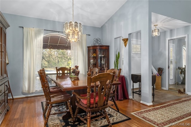 dining space featuring a notable chandelier and wood-type flooring