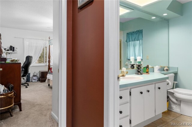 bathroom featuring tile patterned floors, vanity, and toilet