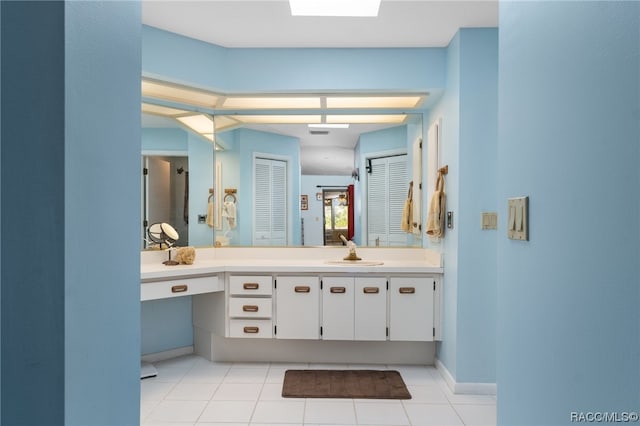 bathroom with tile patterned floors and vanity