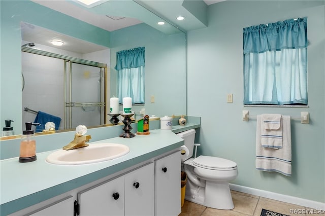 bathroom with toilet, vanity, tile patterned floors, and walk in shower