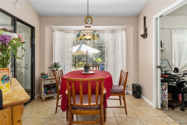 dining space featuring light tile patterned floors