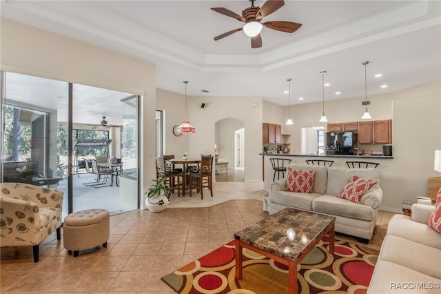 tiled living room featuring ceiling fan