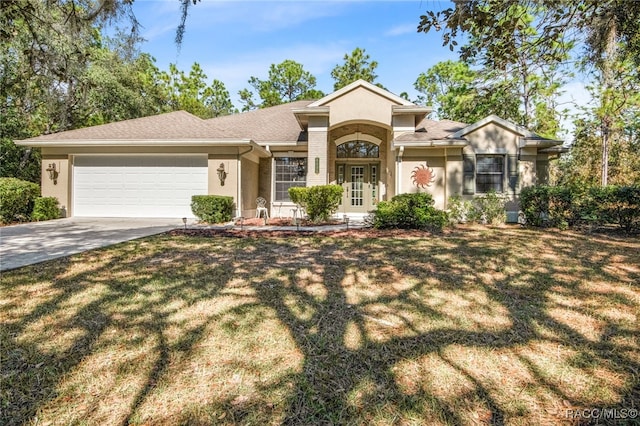 view of front facade with a front yard and a garage