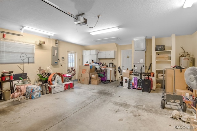 garage featuring electric panel, water heater, a garage door opener, and white refrigerator