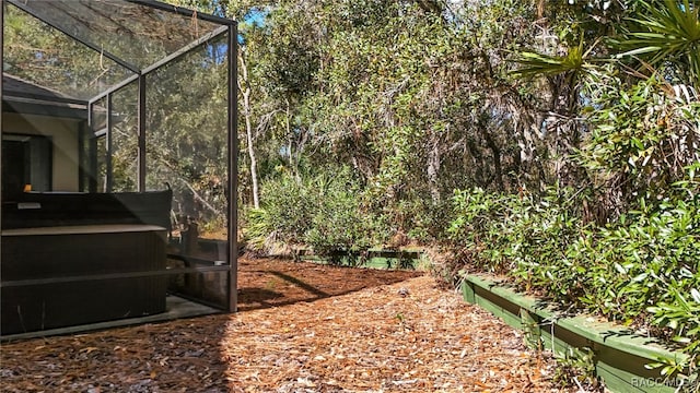 view of yard featuring glass enclosure