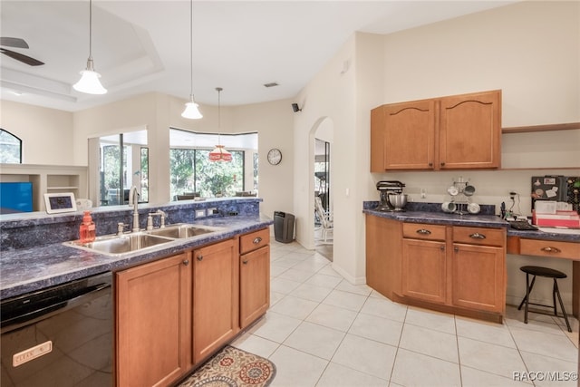 kitchen with sink, black dishwasher, pendant lighting, a tray ceiling, and light tile patterned flooring