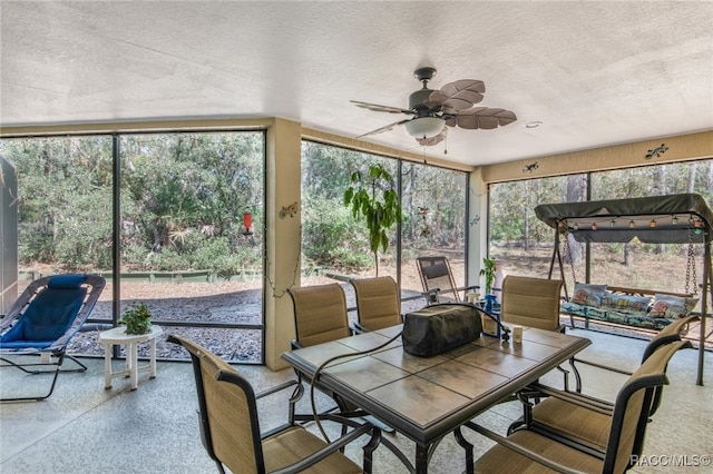 sunroom with plenty of natural light and ceiling fan