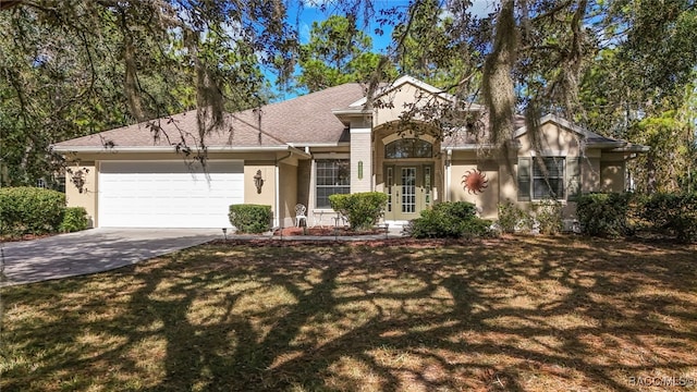 view of front of home with a front lawn and a garage