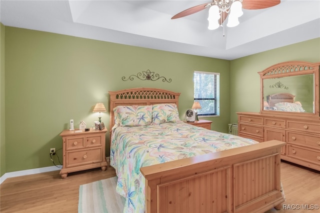 bedroom with ceiling fan and light hardwood / wood-style floors