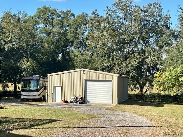 view of outdoor structure with a yard and a garage