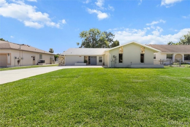 3835 N Eagle Pt, Crystal River, FL 34428 - rear view of house featuring driveway, a lawn, and stucco siding