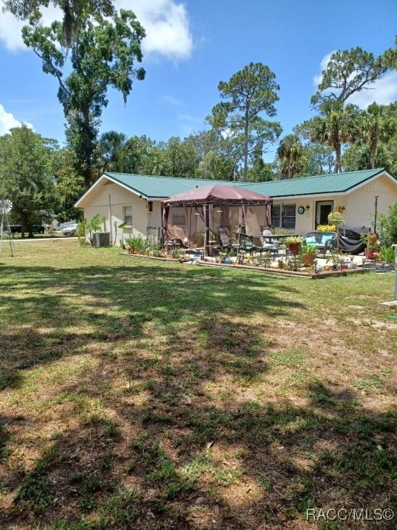 9461 W Tall Pines Ct, Crystal River, FL 34428 - view of green lawn with a patio