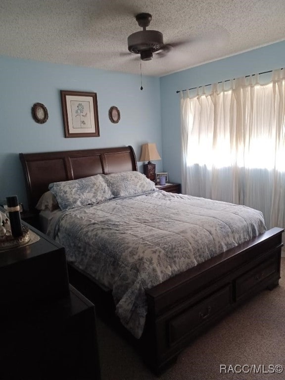 9461 W Tall Pines Ct, Crystal River, FL 34428 - bedroom with a textured ceiling, carpet flooring, and ceiling fan
