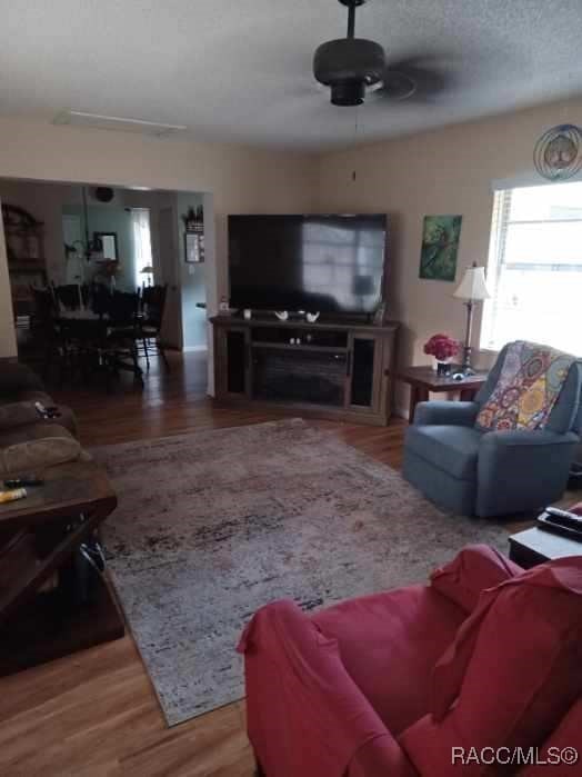 9461 W Tall Pines Ct, Crystal River, FL 34428 - living room featuring wood finished floors and a ceiling fan