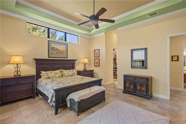 1626 N Eagle Ridge Path, Hernando, FL 34442 - bedroom with crown molding, a walk in closet, baseboards, ceiling fan, and a closet