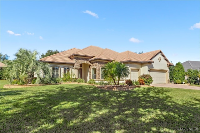 mediterranean / spanish-style house with a garage and a front lawn