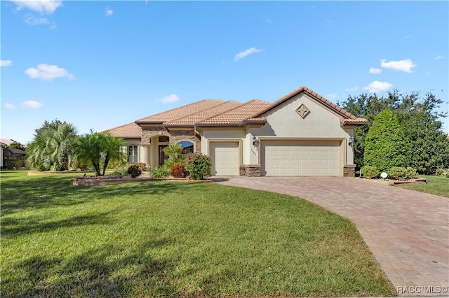 mediterranean / spanish-style home with a garage and a front yard