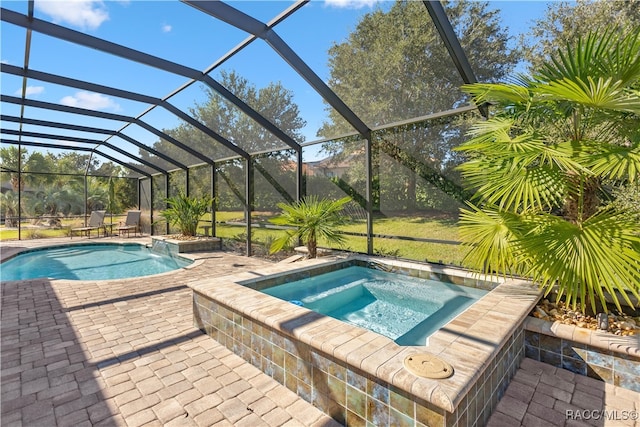 view of swimming pool featuring a lanai, an in ground hot tub, and a patio