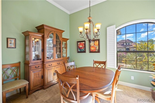 1626 N Eagle Ridge Path, Hernando, FL 34442 - dining room featuring a chandelier, ornamental molding, a high ceiling, and baseboards