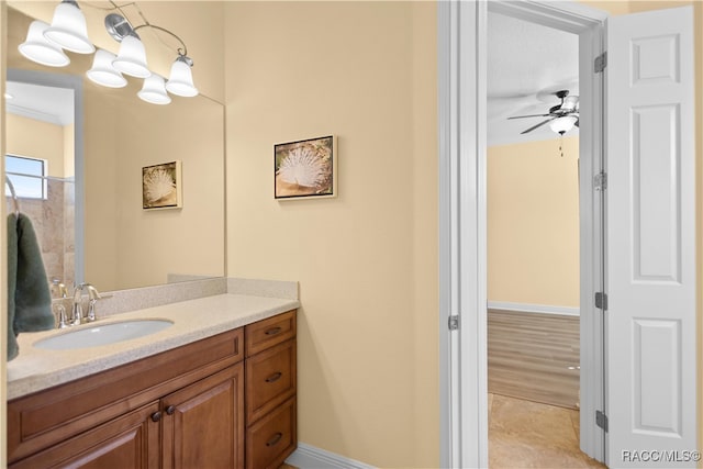 bathroom with hardwood / wood-style flooring, vanity, ceiling fan, and crown molding