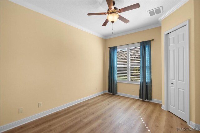 1626 N Eagle Ridge Path, Hernando, FL 34442 - unfurnished bedroom with crown molding, light wood-style flooring, baseboards, a closet, and ceiling fan