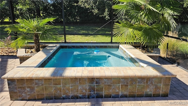 view of swimming pool featuring an in ground hot tub and glass enclosure