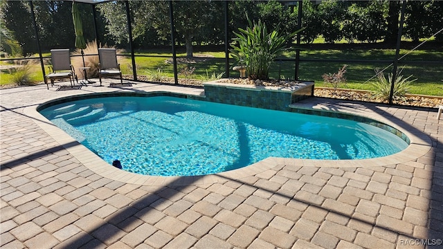 view of pool featuring a lanai and a patio