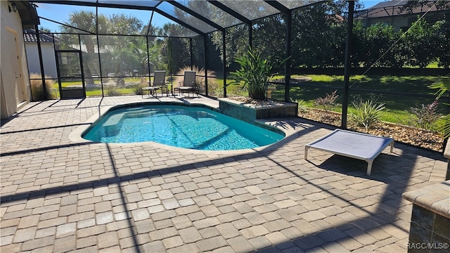 view of pool with a patio and glass enclosure