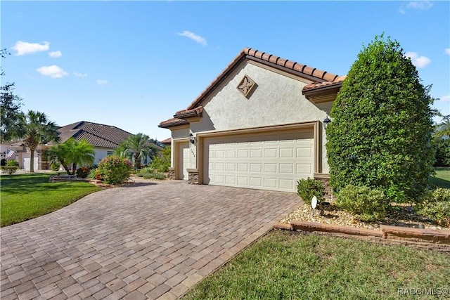 mediterranean / spanish-style house with a garage and a front lawn