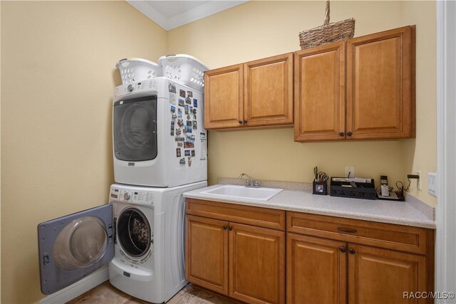 1626 N Eagle Ridge Path, Hernando, FL 34442 - laundry room with cabinet space, stacked washer / drying machine, and crown molding