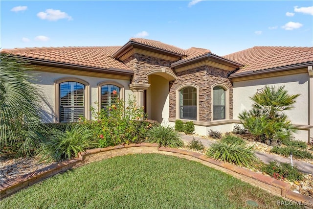 1626 N Eagle Ridge Path, Hernando, FL 34442 - mediterranean / spanish-style home with stucco siding, a tiled roof, stone siding, and a front lawn