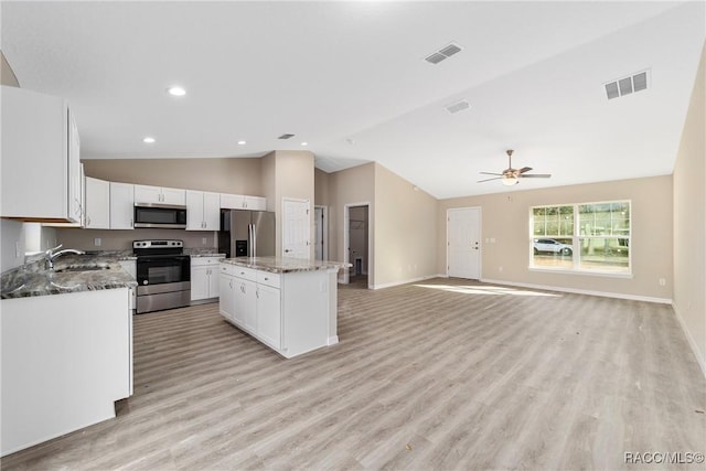 kitchen featuring a center island, white cabinetry, stainless steel appliances, light hardwood / wood-style floors, and ceiling fan