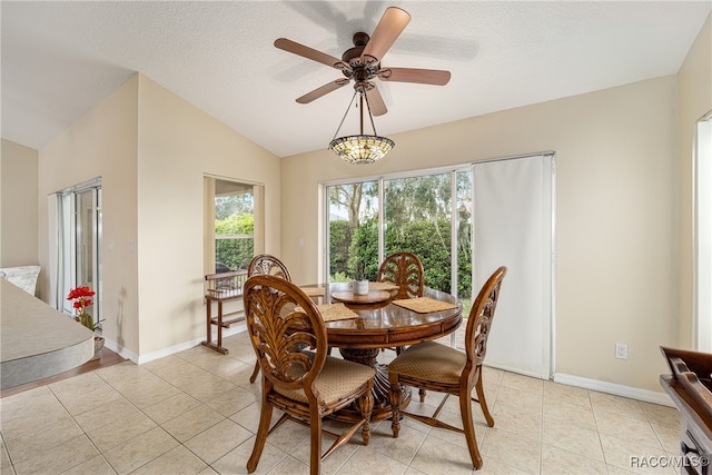 tiled dining room featuring a textured ceiling, vaulted ceiling, and ceiling fan