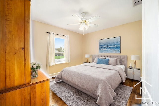 bedroom featuring ceiling fan and dark wood-type flooring