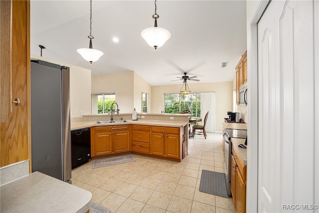 kitchen featuring ceiling fan, sink, hanging light fixtures, stainless steel appliances, and kitchen peninsula