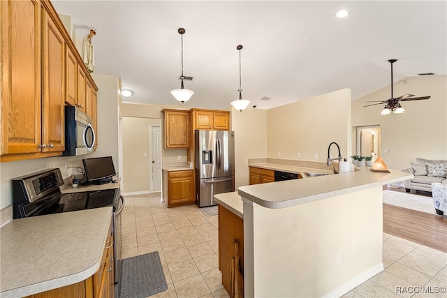 kitchen featuring appliances with stainless steel finishes, a large island with sink, and lofted ceiling