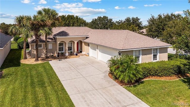 view of front of home with a garage and a front lawn