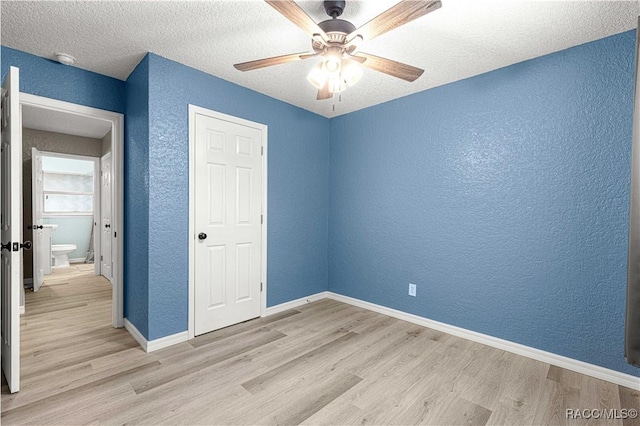 unfurnished bedroom with ceiling fan, a textured ceiling, and light hardwood / wood-style flooring