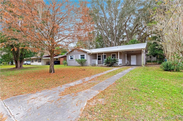 ranch-style house featuring a front yard and a carport