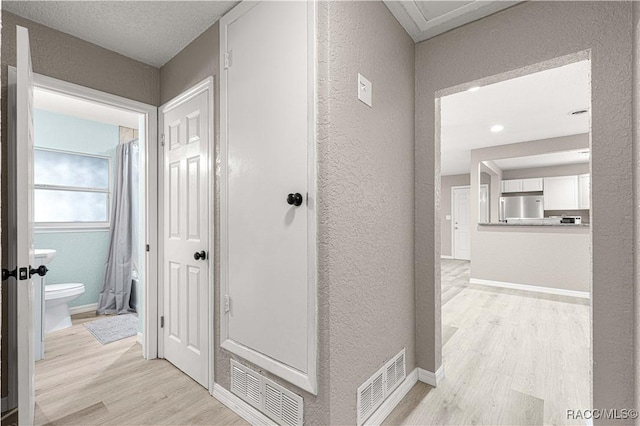 hallway with light wood-type flooring