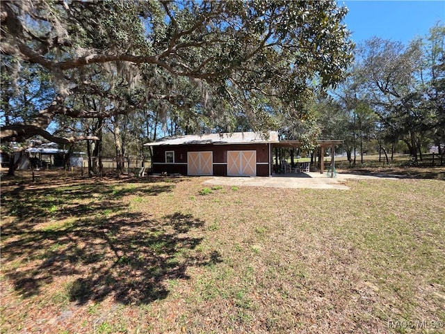 view of yard featuring a barn and an outdoor structure