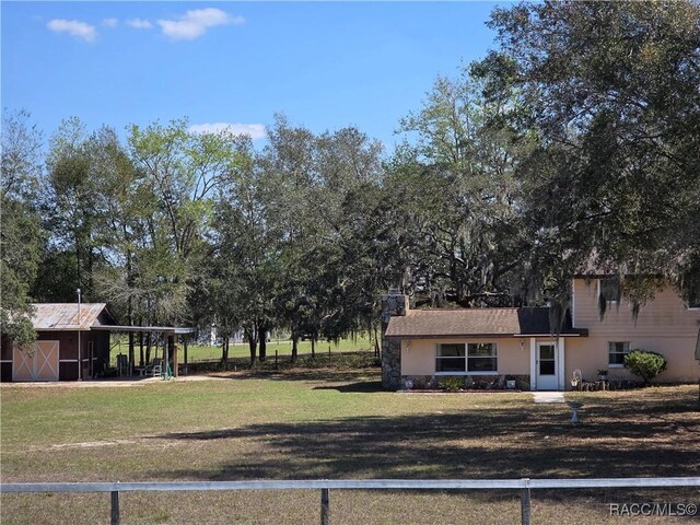 exterior space featuring a carport and an outbuilding