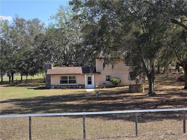 view of front of house with a fenced front yard and a front lawn