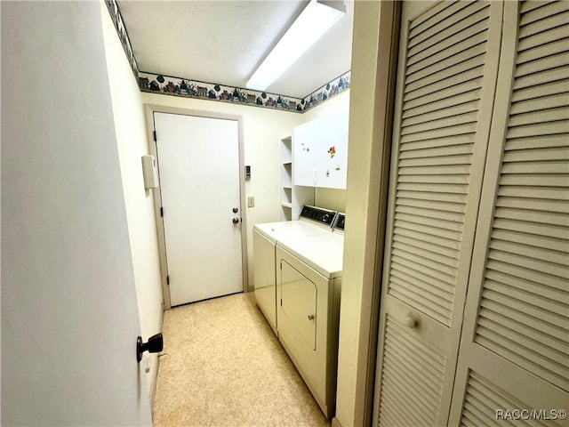 laundry area with cabinet space and separate washer and dryer